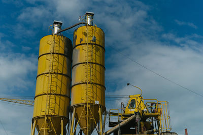 Low angle view of smoke stack against sky