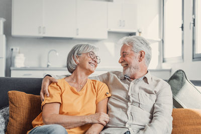 Portrait of family sitting on sofa at home