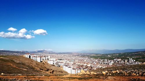 View of townscape against blue sky