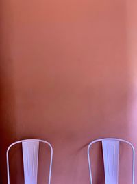 Close-up of empty coffee cup on table against wall