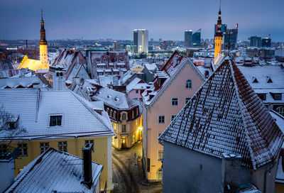 High angle view of illuminated buildings against sky during winter