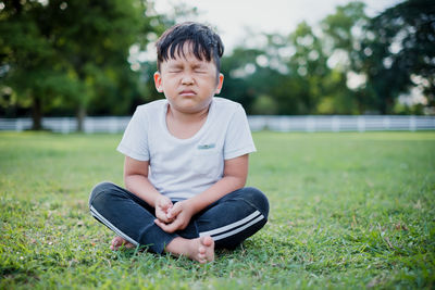 Boy sitting on grass