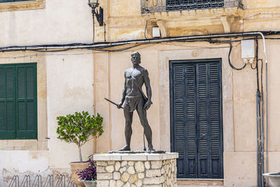 Statue against building