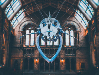 Low angle view of ornate hanging outside building