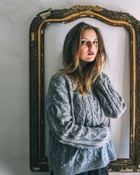 Young woman standing at home
