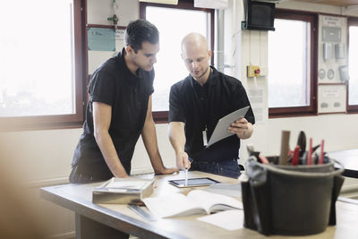 Teacher assisting student on project in training class