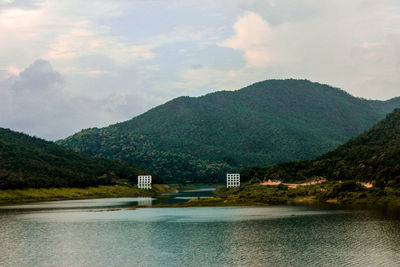 Scenic view of lake and mountains against sky