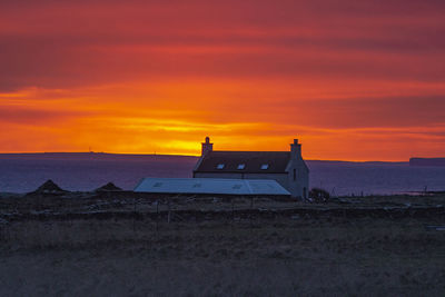 Scenic view of sea against orange sky