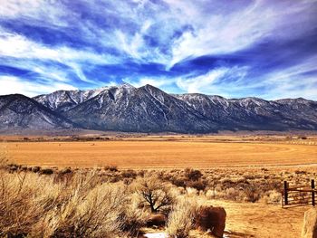 Scenic view of mountains against cloudy sky