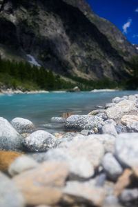 Surface level of rocks at shore against sky