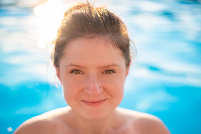 Young woman portrait in swimming pool. copy space