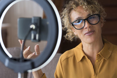 Portrait of woman vlogging at home