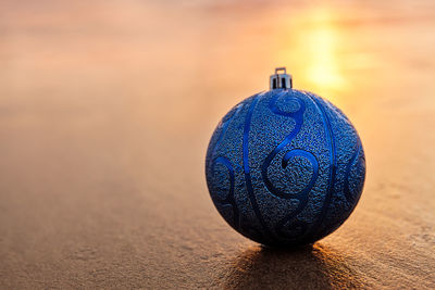 Close-up of christmas ornament on beach