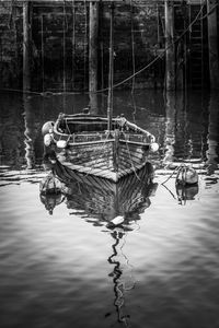 Reflection of  boat moored in lake