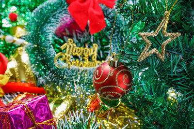 Close-up of christmas decorations hanging on tree