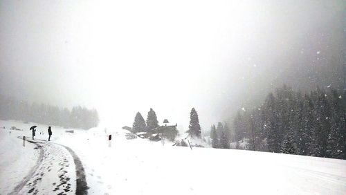 Road passing through snow covered landscape