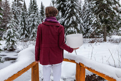 Rear view of child on snow covered land