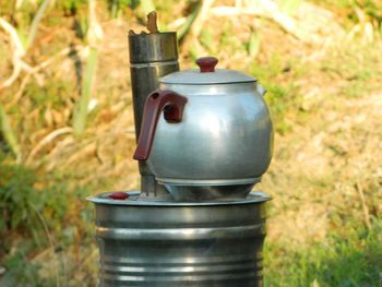 Close-up of metal container on field