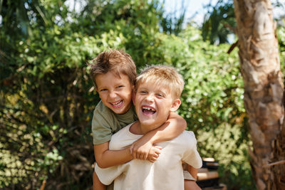 Portrait of two smiling boys with green background 