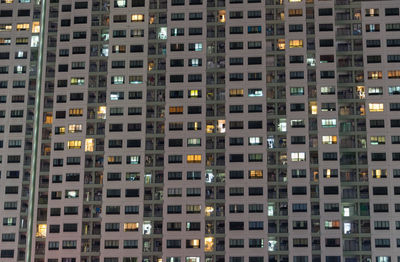 Full frame shot of illuminated apartment building at night