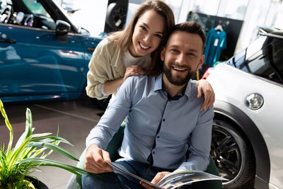 Portrait of happy friends sitting in car