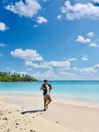 Full length of man on beach against sky