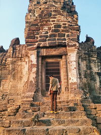 Rear view of man standing on steps