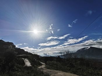 Scenic view of landscape against sky on sunny day