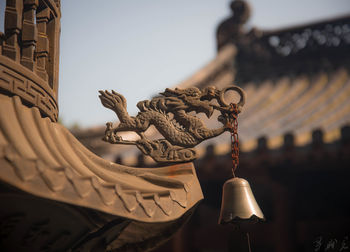 Close-up of bell hanging on roof