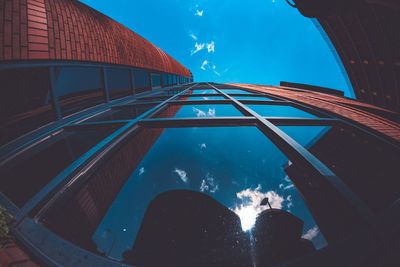 Low section of person by swimming pool against sky