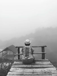 Rear view of man on staircase against sky