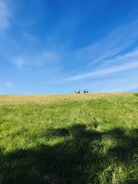 People on field against sky