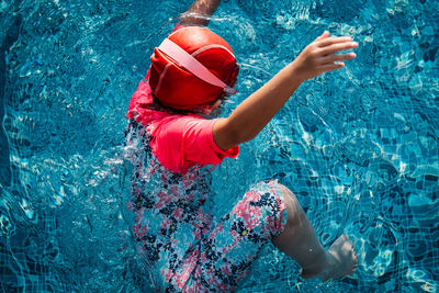 Low section of boy swimming in pool