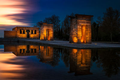 Reflection of illuminated temple of debod in pond