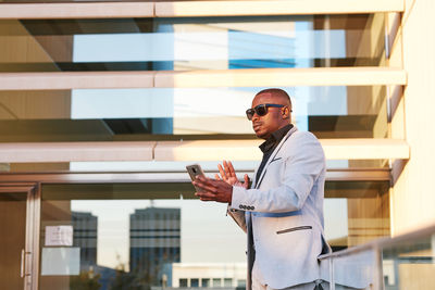 African american businessman with mobile phone on a summer afternoon.