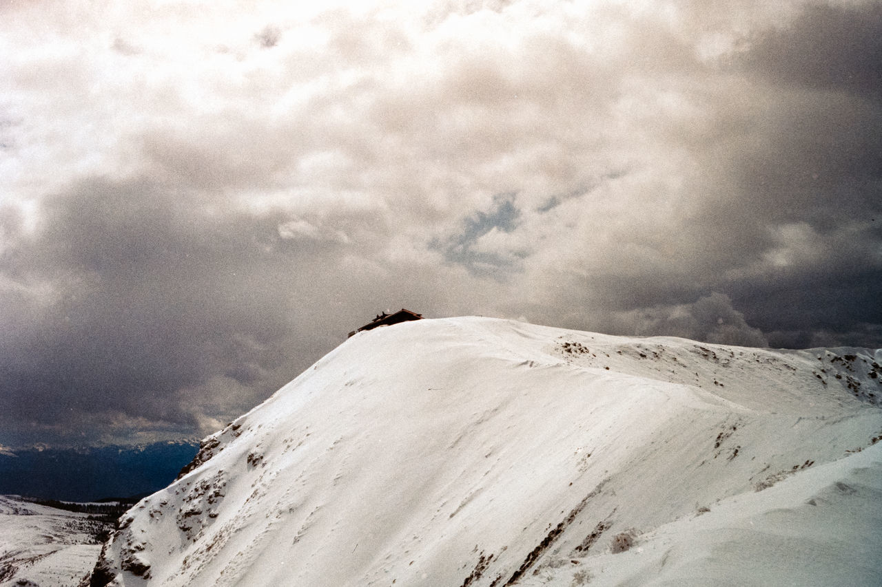 cloud, sky, environment, snow, landscape, scenics - nature, mountain, cold temperature, winter, beauty in nature, nature, mountain range, snowcapped mountain, travel destinations, tranquility, travel, tranquil scene, land, non-urban scene, dramatic sky, no people, tourism, extreme terrain, outdoors, day, overcast, white, adventure, vacation, trip, remote