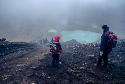 Rear view of woman standing on mountain