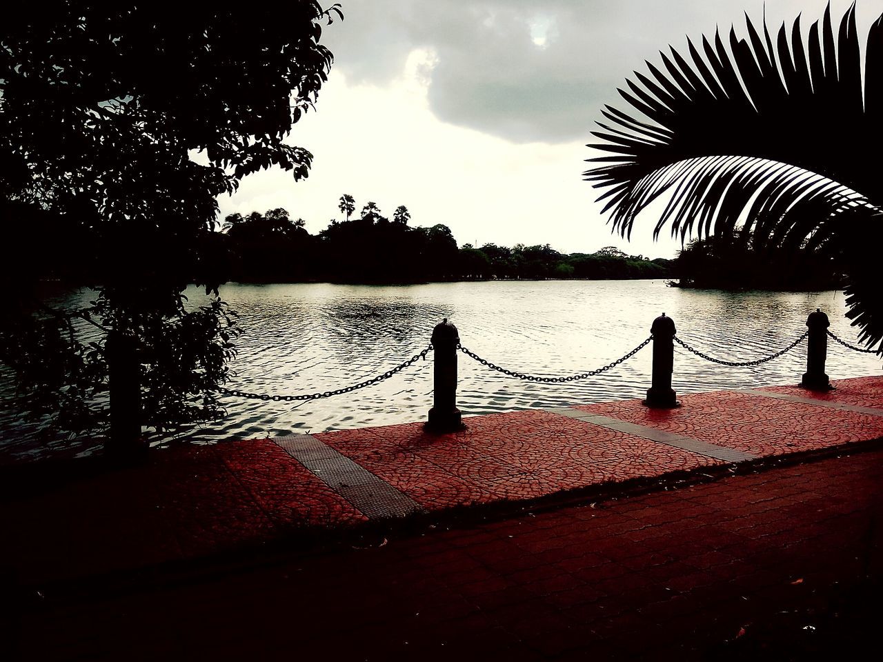 water, silhouette, sky, tranquility, railing, tranquil scene, tree, sunset, sea, lake, cloud - sky, scenics, nature, beauty in nature, pier, river, idyllic, dusk, rippled, cloud