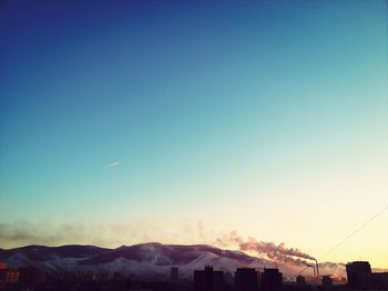 Scenic view of mountains against blue sky