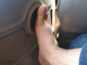 High angle view of man legs in car