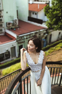 This captivating photograph features a stunning asian woman in a unique white wedding dress
