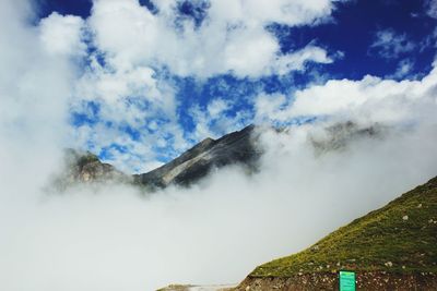 Scenic view of mountains against cloudy sky