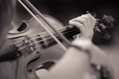 Midsection of woman playing guitar