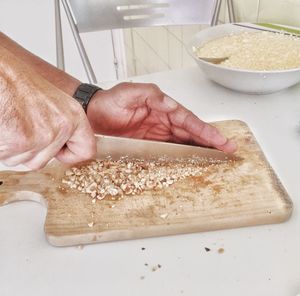 High angle view of man preparing food on cutting board