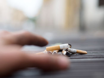 Cropped image of hand reaching cigarette