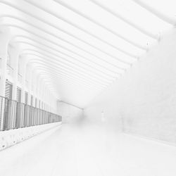 Empty white corridor along walls