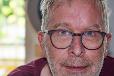 Close-up portrait of man wearing eyeglasses