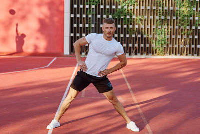 Full length of man playing tennis