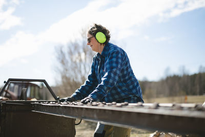 Mature woman working in sawmill