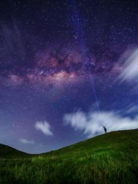 Scenic view of field against sky at night